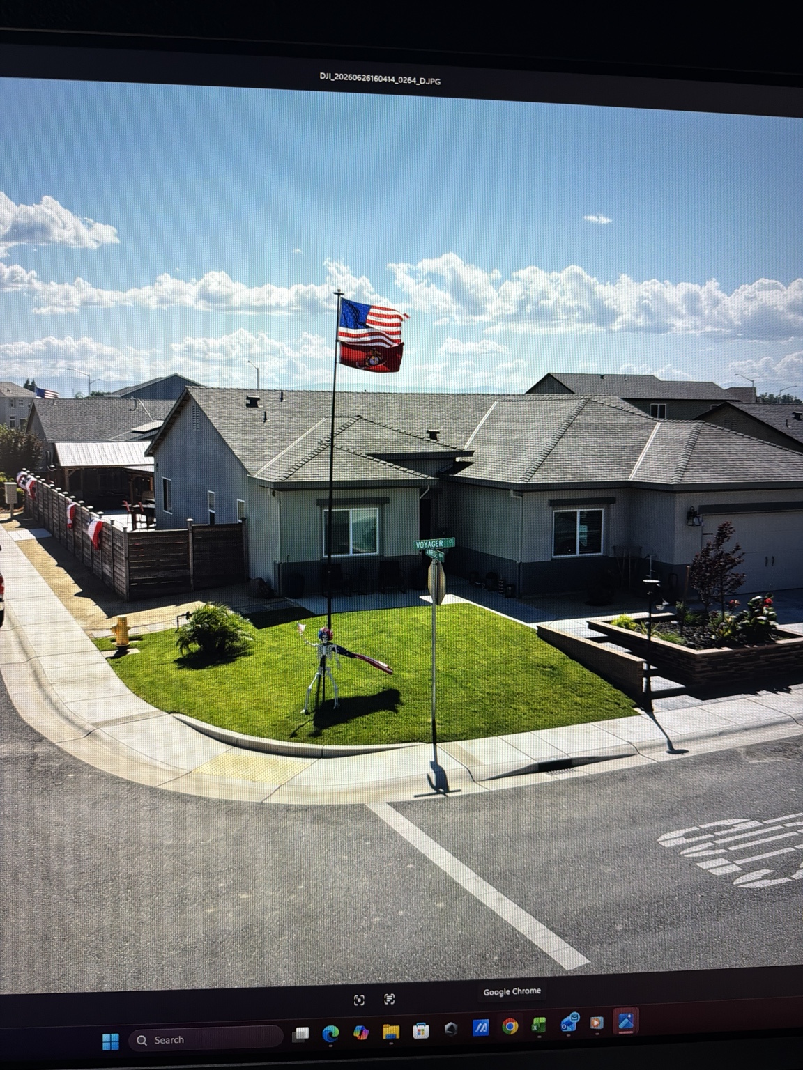 Completed residential landscape with a lawn, trees, and planted garden beds